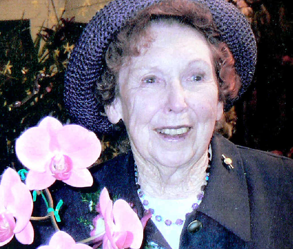 COLOUR PURPLE: Joan with the orchid named in her honour by the Woodburn Orchid Society. COLOUR PURPLE: Joan with the orchid named in her honour by the Woodburn Orchid Society.